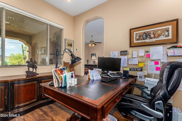 office space featuring arched walkways, ceiling fan, and wood finished floors