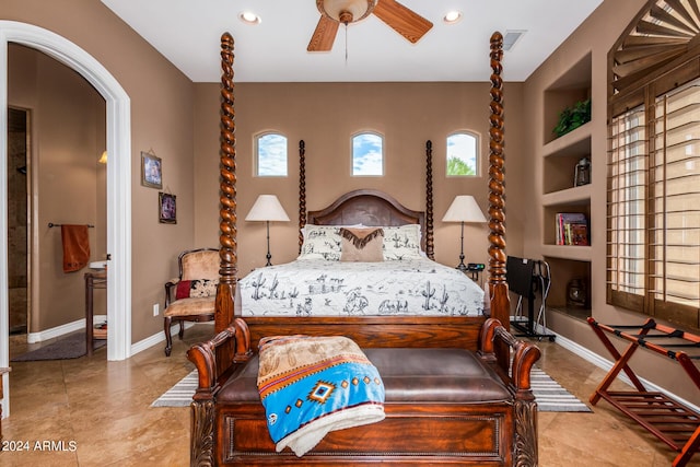 bedroom featuring arched walkways, recessed lighting, multiple windows, and baseboards