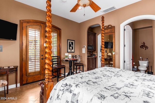 bedroom featuring tile patterned flooring, arched walkways, visible vents, and baseboards