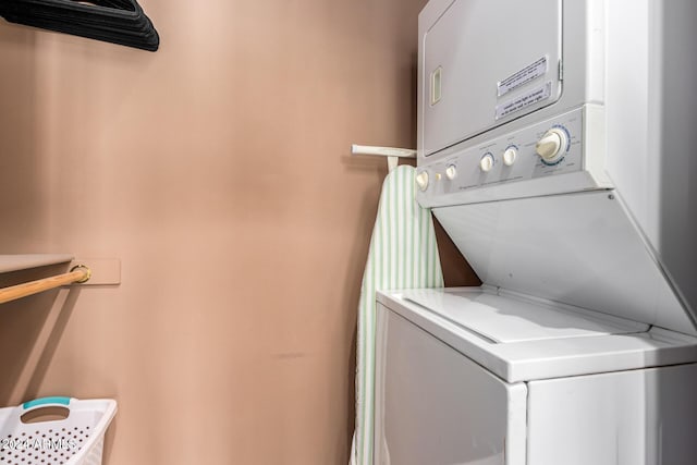 clothes washing area with laundry area and stacked washer / drying machine