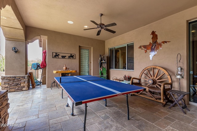 recreation room with a ceiling fan, stone tile floors, and recessed lighting