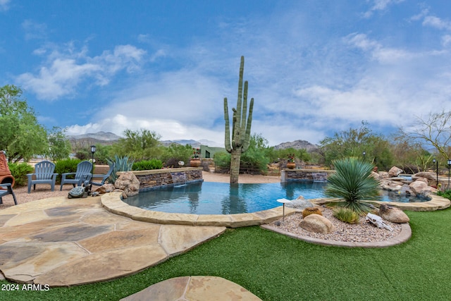 view of swimming pool featuring a mountain view and pool water feature