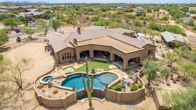 view of swimming pool featuring a patio, a fenced backyard, and an in ground hot tub