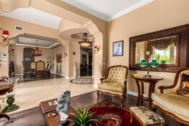 interior space with visible vents, arched walkways, a raised ceiling, and ornamental molding