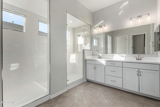 bathroom featuring vanity, a tile shower, and tile patterned floors