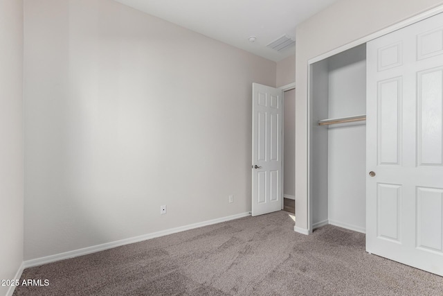 unfurnished bedroom with a closet and light carpet