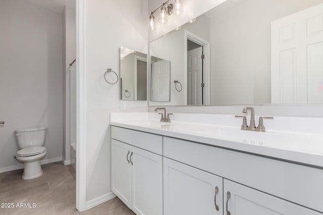 bathroom with toilet and vanity