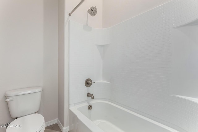 bathroom featuring toilet and shower / tub combination