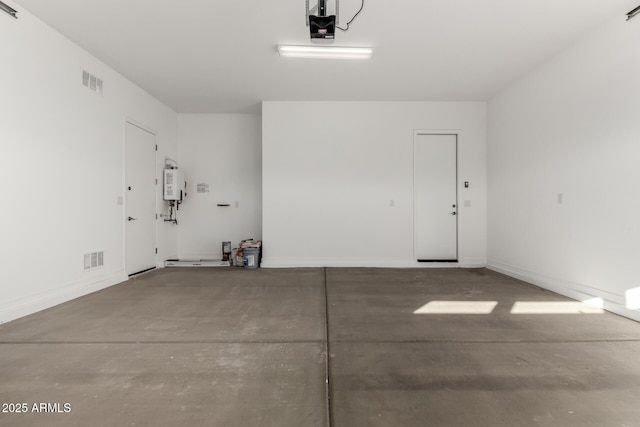 garage featuring water heater and a garage door opener