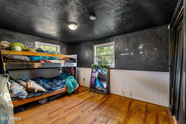 1326 W Apache Ln, Pinetop-Lakeside, AZ 85929 - bedroom featuring a wainscoted wall and hardwood / wood-style floors