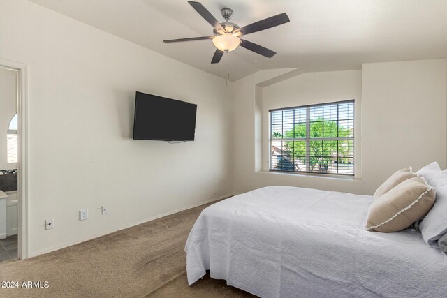 bedroom featuring lofted ceiling, ceiling fan, ensuite bath, and carpet floors