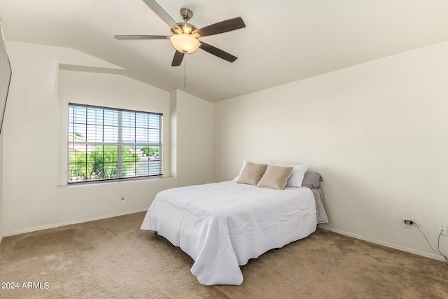 carpeted bedroom with ceiling fan and vaulted ceiling