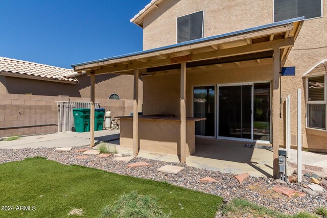 back of property with a patio