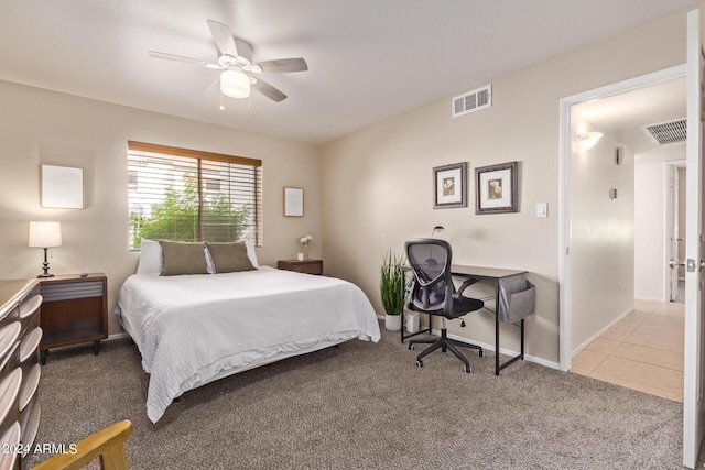 carpeted bedroom with tile patterned flooring, visible vents, baseboards, and a ceiling fan