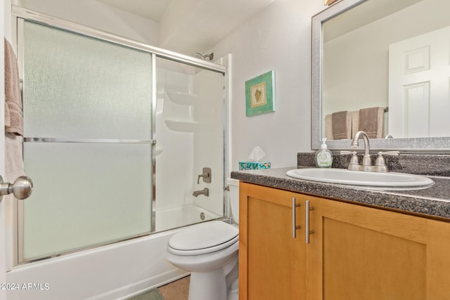 bathroom featuring enclosed tub / shower combo, tile patterned flooring, toilet, and vanity