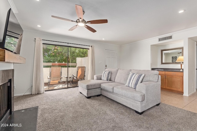 living room with visible vents, a fireplace with flush hearth, a ceiling fan, recessed lighting, and crown molding