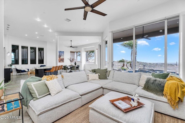 living area with visible vents, recessed lighting, and a ceiling fan