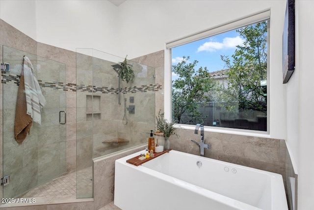 bathroom with a soaking tub and a stall shower