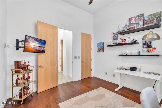 office with baseboards and wood finished floors