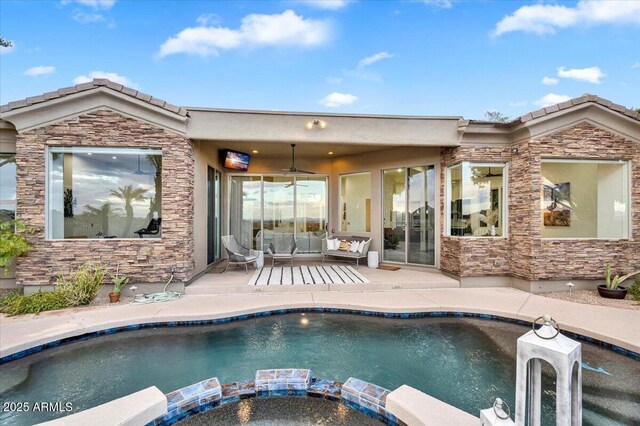 outdoor pool with a patio, a ceiling fan, and an in ground hot tub