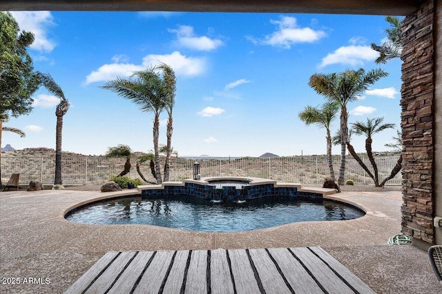 view of swimming pool with a patio, a pool with connected hot tub, and a fenced backyard