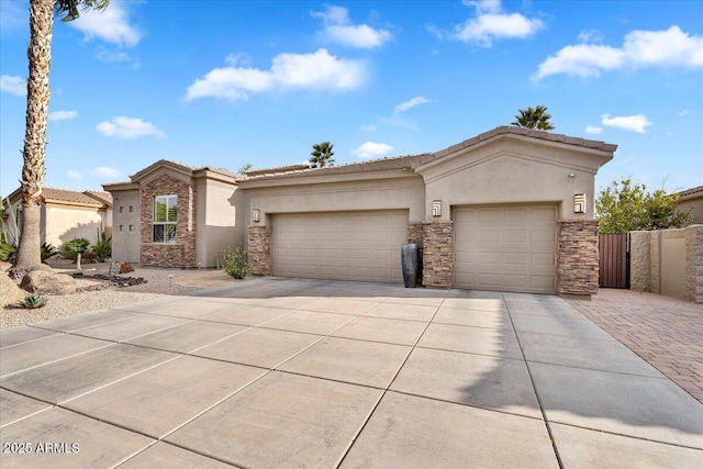 view of front of property featuring a tile roof, stucco siding, driveway, stone siding, and an attached garage