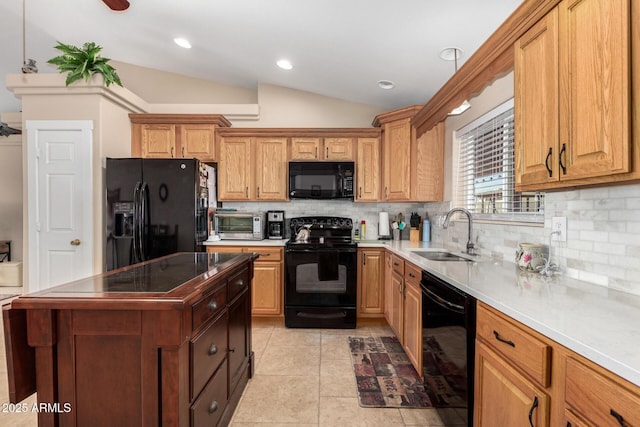 kitchen with pendant lighting, sink, black appliances, decorative backsplash, and vaulted ceiling