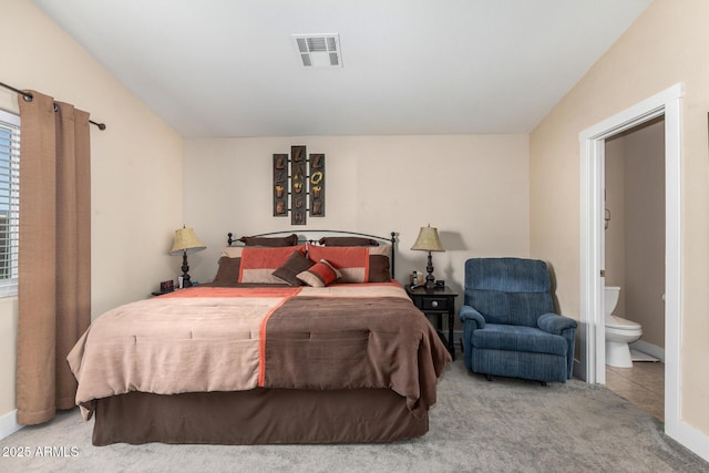 carpeted bedroom featuring connected bathroom