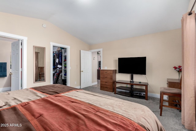 bedroom featuring vaulted ceiling, a walk in closet, carpet, and a closet