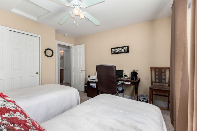 carpeted bedroom with ceiling fan and a closet