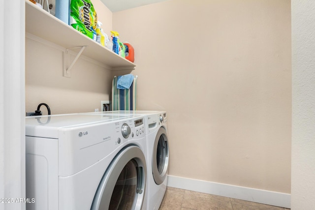 clothes washing area with independent washer and dryer and light tile patterned floors