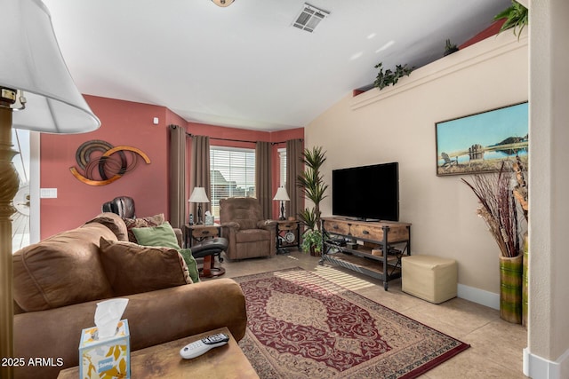 living room featuring lofted ceiling and light tile patterned floors