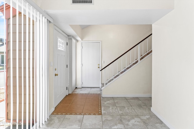 entrance foyer with light tile patterned floors