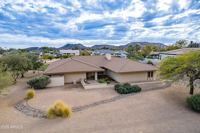 ranch-style home with a mountain view and a patio area