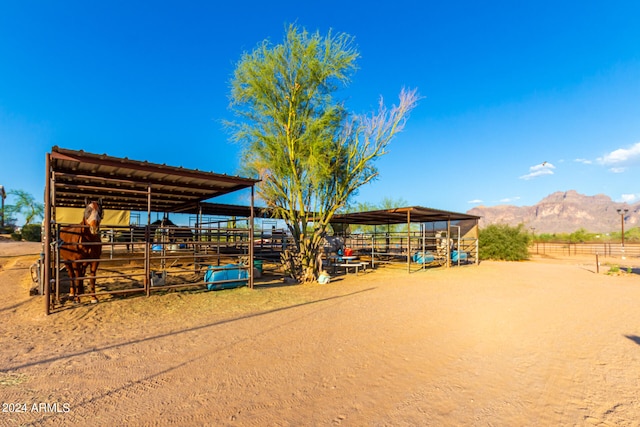 exterior space featuring a rural view, an outbuilding, and a mountain view