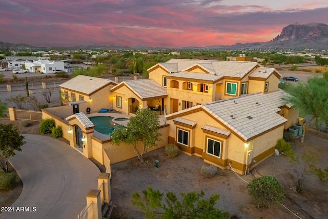 aerial view at dusk featuring a mountain view