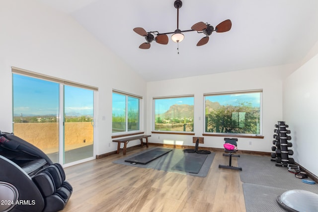 workout area featuring high vaulted ceiling, hardwood / wood-style flooring, and ceiling fan