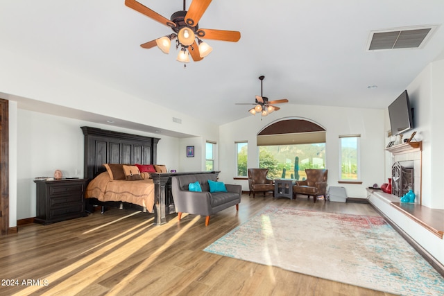 bedroom with hardwood / wood-style floors, ceiling fan, and vaulted ceiling