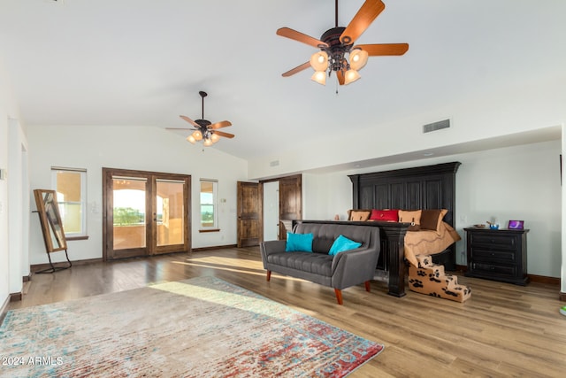 bedroom with ceiling fan, access to outside, french doors, high vaulted ceiling, and hardwood / wood-style flooring