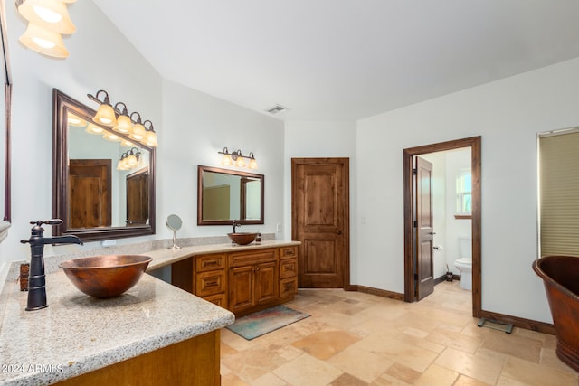 bathroom with vanity and toilet