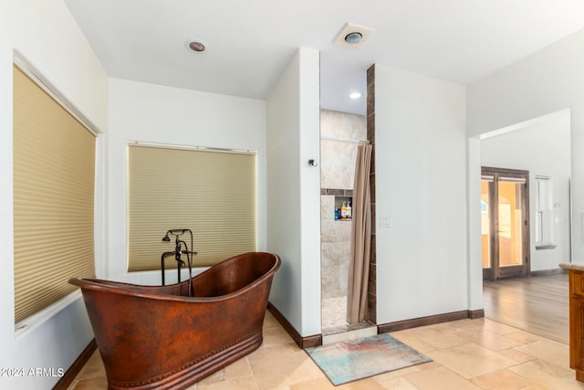 bathroom with separate shower and tub