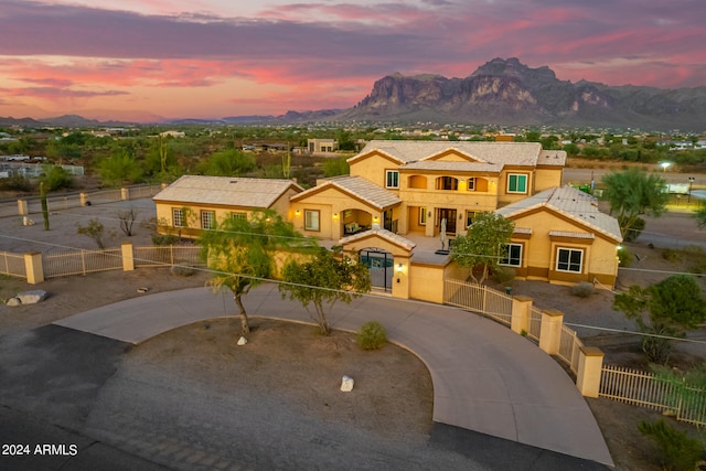 view of front of house featuring a mountain view and a balcony