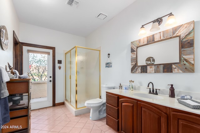 bathroom featuring vanity, a shower with shower door, toilet, and tile patterned floors