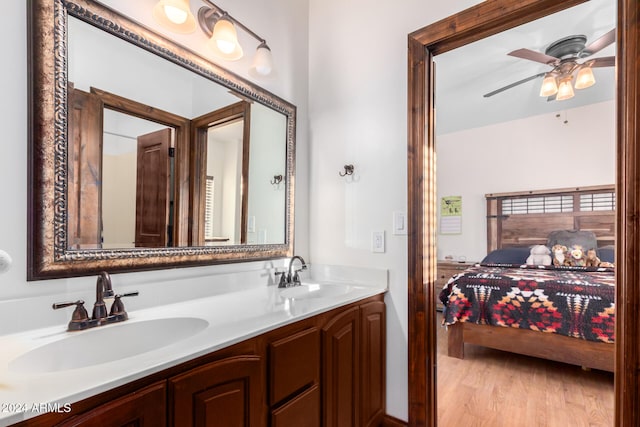 bathroom featuring wood-type flooring, vanity, and ceiling fan