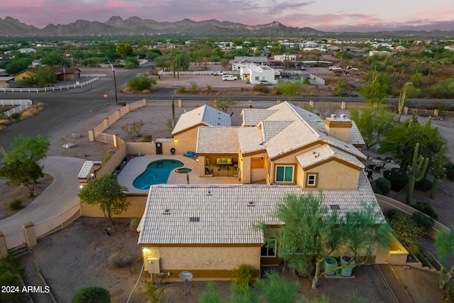 aerial view at dusk featuring a mountain view