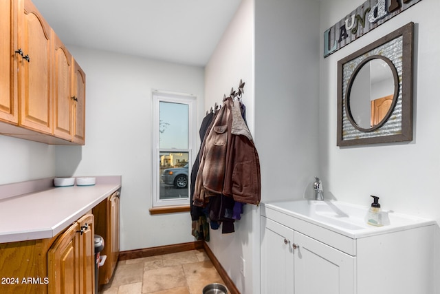 laundry area with cabinets