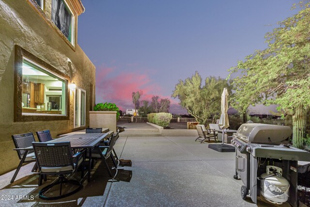 patio terrace at dusk with a grill