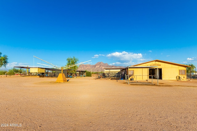 view of playground with a mountain view and an outdoor structure