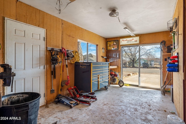 interior space featuring wood walls and a workshop area