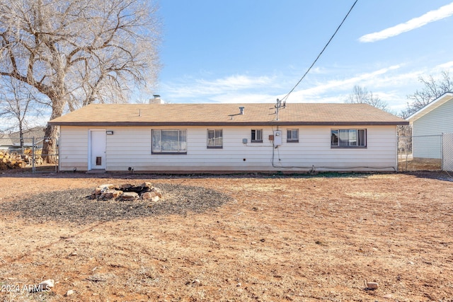 back of house featuring fence